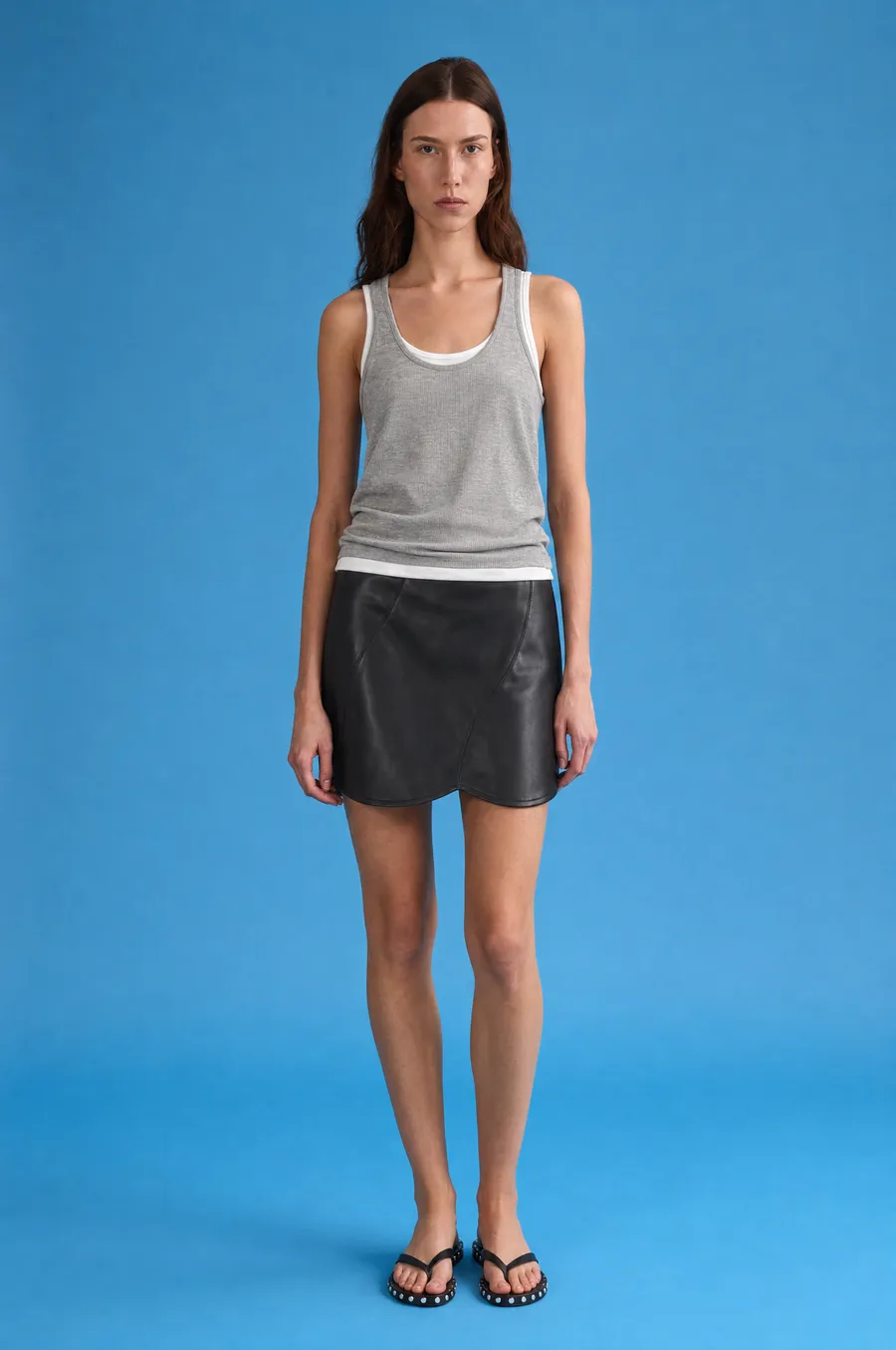 Delucca Spring Collection: on-model look 2 on a blue studio backdrop