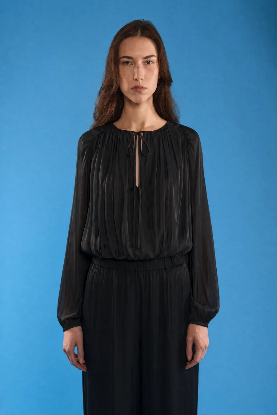 Delucca Spring Collection: on-model look 5 on a blue studio backdrop