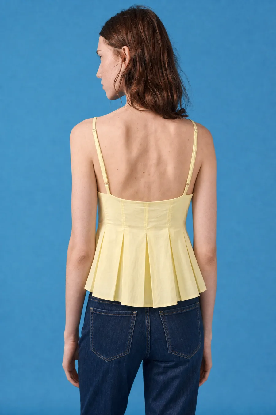 Delucca Spring Collection: on-model look 7 on a blue studio backdrop