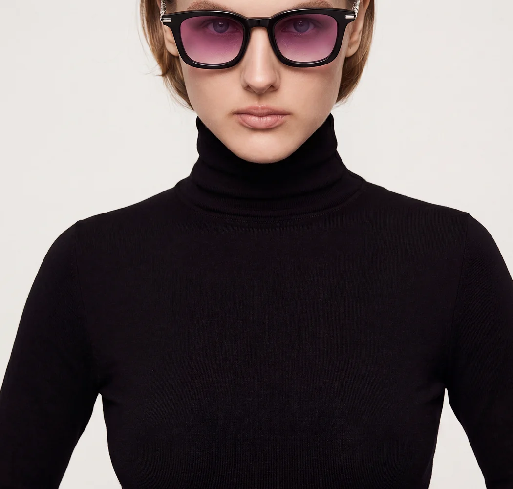 Model in a black turtleneck facing forward wearing the pink-lens sunglasses